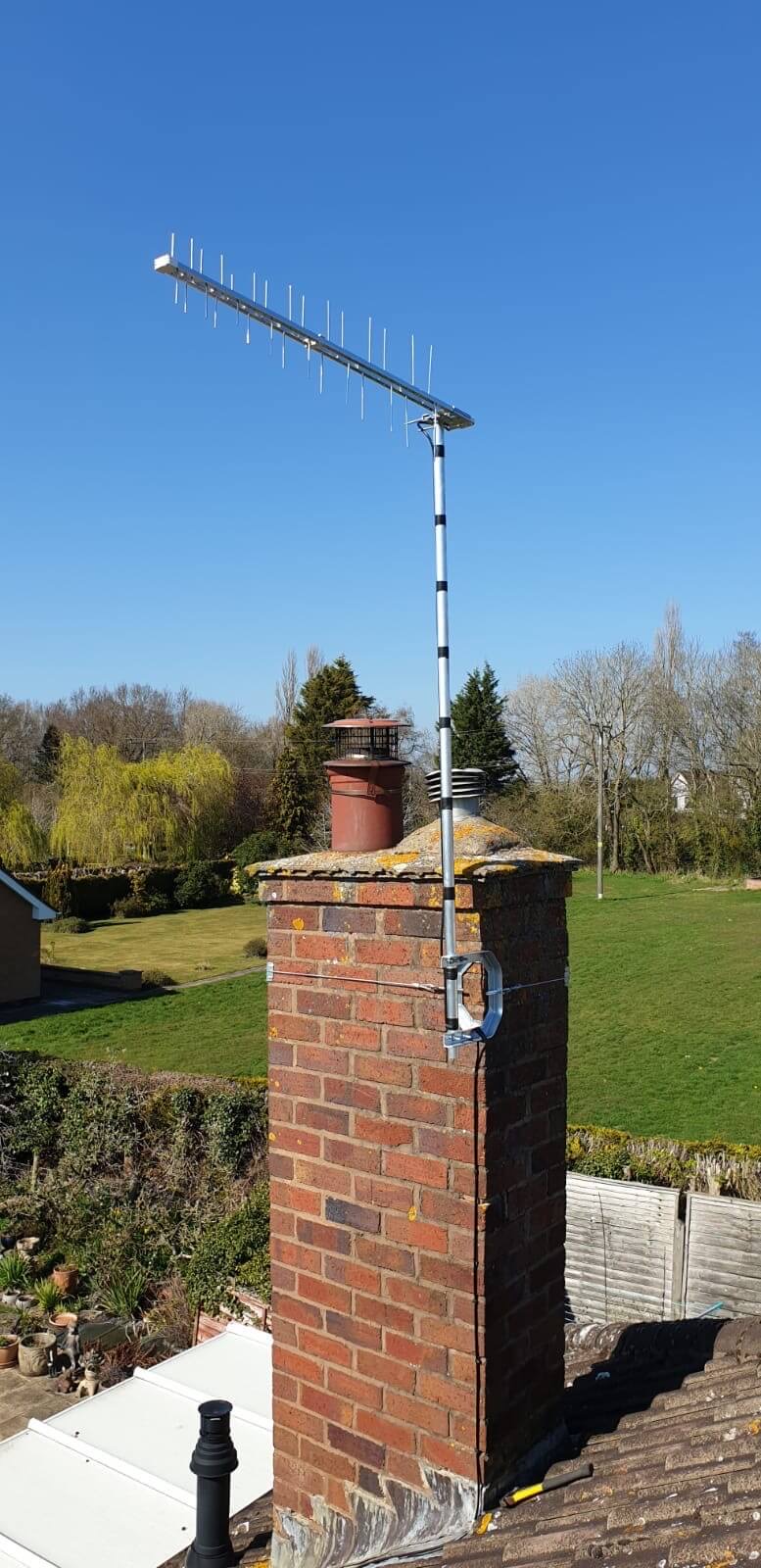 High-gain TV aerial securely installed above a chimney
